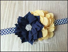 a blue and yellow headband with flowers on it