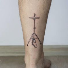 a tattoo on the leg of a man with a musical instrument in front of him