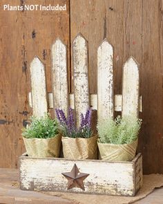 an old wooden box with some plants in it and a star on the front side