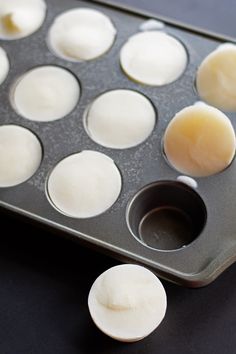 an uncooked muffin pan with several eggs in it