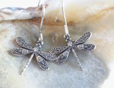 "Detailed antiqued silver charms make an adorable little pair of dragonfly earrings. These small dragonfly earrings come with your choice of ear wires so even sensitive ears will be happy wearing these all day long. ♥ 1 1/8 inches long - may change slightly with your ear wire selection ♥ 1/3 inches wide ♥ Antiqued silver plated dragonflies ♥ Nickel and lead-free ♥ Your choice of ear wires: - stainless steel - stainless steel lever back - silver plated - silver plated lever back - sterling silver Whimsical Silver Hypoallergenic Earrings, Silver Dragonfly Earrings For Gift, Nickel-free Dragonfly Sterling Silver Earrings, Silver Dragonfly Earrings Perfect For Gifts, Nickel-free Sterling Silver Dragonfly Earrings, Dragonfly-shaped Pierced Earrings As Gift, Silver Sterling Dragonfly Earrings, Sterling Silver Dragonfly Earrings, Hypoallergenic Dragonfly Earrings As A Gift