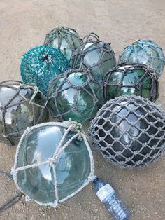 several glass balls and nets on the ground