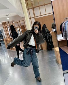 a woman taking a selfie in a clothing store