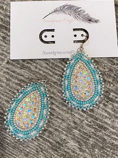 ALL ITEMS ARE MADE TO ORDER AND DONE IN ORDER OF PURCHASE  Sparkling silver & turquoise beaded teardrop earrings with white lined and silver seed beads, with a sparkling beaded border to make them really stand out  These stunning earrings have a stainless steel post earring, white leather backing making them comfortable to wear, they measure 1 1/2" inches wide & 2" inches long. These will sparkle and shine in natural or artificial light, would be a fabulous earring for any type of wedding as well as every day with jeans. I am First Nation, Plains Cree so you are buying authentic items made by myself. Native Wedding, Beaded Teardrop Earrings, Turquoise Bead Earrings, Earrings Turquoise, Steel Post, White Turquoise, Earrings Unique, Earrings White, Stunning Earrings