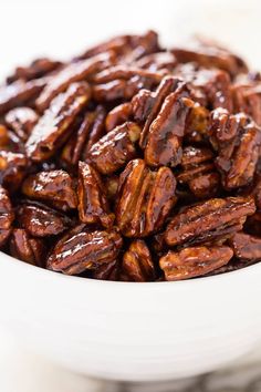 a white bowl filled with nuts on top of a table