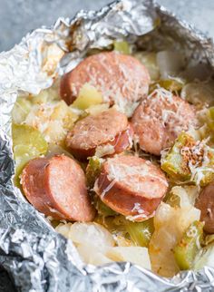 hot dogs and vegetables wrapped in aluminum foil