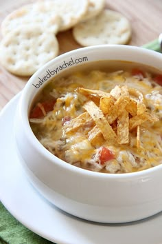 a bowl of soup with crackers on the side