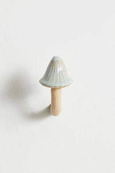 a small ceramic mushroom sitting on top of a white wall