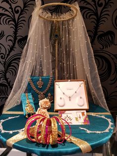 a table topped with jewelry and a veil