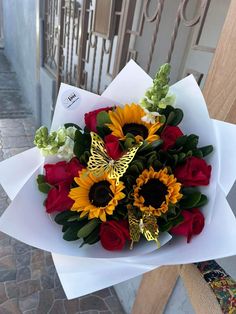 a bouquet of sunflowers, roses and other flowers