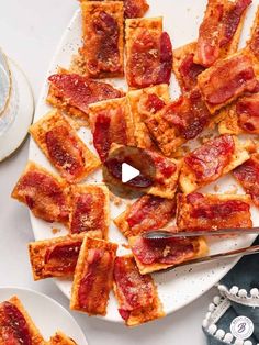 pizza slices are arranged on a plate with a knife and fork next to them, ready to be eaten