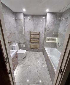 a bathroom with marble floors and walls