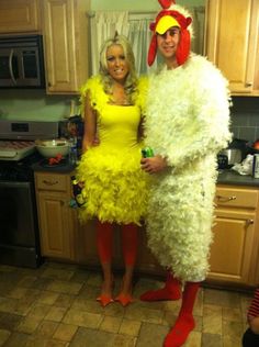 two people dressed up as chicken and rooster in the kitchen, one is wearing a yellow dress