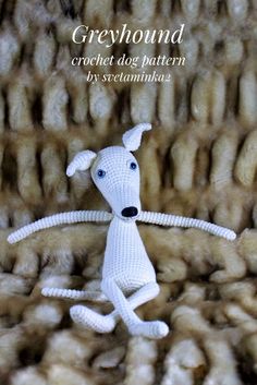 a small white dog sitting on top of a pile of sheep wool with the caption greyhound crochet dog pattern by stephanie