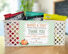 a nurse's and staff thank you card in a basket filled with candy bars