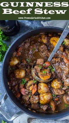 a pot filled with stew and potatoes on top of a table