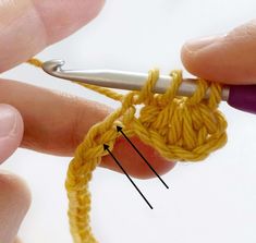 someone is crocheting the ends of a yellow piece of yarn