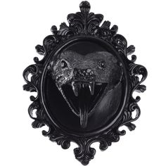 a black and white photo of an animal with its mouth open in a ornate frame