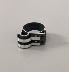 a black and silver ring sitting on top of a table