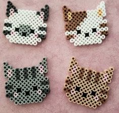 four perler beads are arranged in the shape of cats