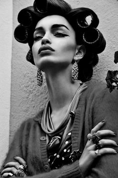 a black and white photo of a woman with her hair in curls on her head