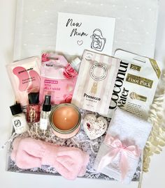 an open gift box containing beauty products and personal care items, such as soaps