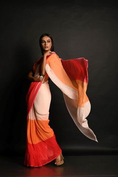 Embrace the vibrant hues of dusk with our Red, Orange, and White Pleated Georgette Saree. This elegant piece combines rich colors in a flowing gradient, crafted from lightweight georgette for effortless draping. Finished with finely done fall and pico, this saree is perfect for adding a touch of sophistication to any occasion. Fusion Style Multicolor Silk Pre-draped Saree, Elegant Multicolor Pre-draped Saree, Elegant Multicolor Pre-draped Saree With Sheer Dupatta, Elegant Red Chiffon Saree, Elegant Multicolor Georgette Saree, Elegant Multicolor Chiffon Saree, Elegance Style, Georgette Saree, Georgette Sarees