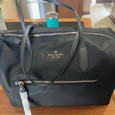 Kate Spade Black New With Tags Overnight Bag Black Top Handle Travel Bag For Shopping, Elegant Top Handle Travel Bag For Shopping, Chic Black Travel Bag With Removable Pouch, Elegant Travel Bag With Top Handle For Shopping, Elegant Crossbody Travel Bag, Elegant Travel Bag With Removable Pouch For Shopping, Elegant Travel Bag With Detachable Handle For Shopping, Elegant Travel Bag With Double Handle And Dust Bag, Elegant Black Travel Bag With Top Carry Handle