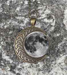 This full moon pendant is cast in a lovely bronze with an intricate moon bordering it. It hangs from a 24 inch bronze chain with lobster clasp. The pendant can also be easily removed from the chain and replaced with one of your own, if you wish. Designed and handcrafted by me in my studio. This beautiful piece makes a wonderful gift.  The pendant measures about 1.5 by 1.5 inches, approximately 38 x 38 mm. It is made of a lightweight yet sturdy metal. I have coated the front image with an epoxy dome to protect it. I ship directly from my studio. I'm a one-woman show but always do my best to respond quickly to messages. Feel free to reach out. Thank you for supporting my handmade business. Witchy Necklace, Full Moon Necklace, Lunar Phases, Lunar Phase, Witchy Jewelry, Small Business Ideas, Handmade Business, Moon Pendant, Moon Necklace