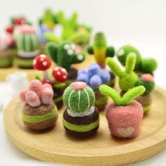 small toy plants and mushrooms on a wooden tray