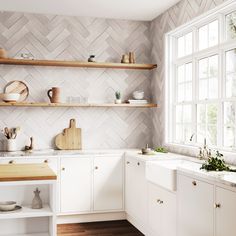 a kitchen with white cabinets and wooden shelves