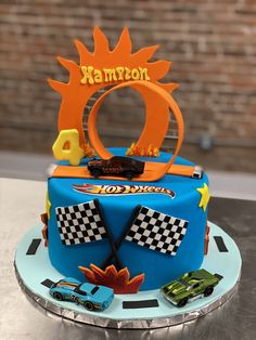 a birthday cake for a boy with cars on it and the number one in the middle