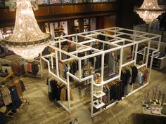 an overhead view of a clothing store with chandelier and clothes on racks in the center