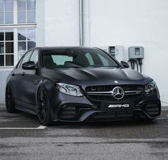 a black car parked in front of a building