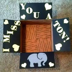 four pieces of cardboard with words and an elephant