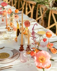 the table is set with flowers and candles