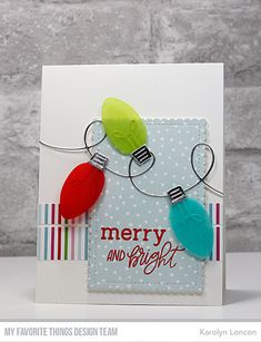 a merry and bright card with some lights hanging from it's side on a table