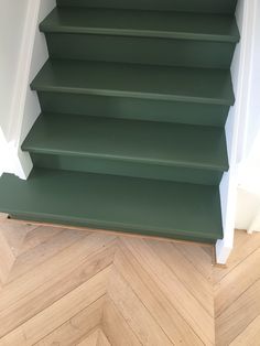 green painted stairs leading up to the second floor