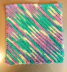 a crocheted square is sitting on a table