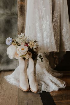 the bride's bouquet is in her cowboy boots