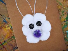 a brown paper bag with white and purple decorations on it