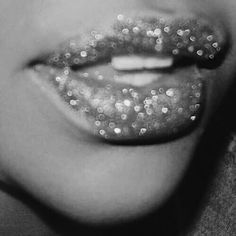 black and white photograph of woman's lips with glitter on them