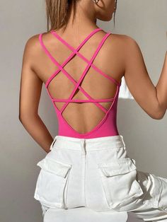 This Criss Cross Backless Cami Bodysuit is the perfect addition to any wardrobe! It features a unique criss-cross back, fringe detailing, and tie-back straps for an eye-catching look. The fabric used is a blend of polyester and spandex which gives it slight stretch while still being lightweight. This bodysuit has a halter neckline and skinny fit that hugs your curves in all the right places. It's also machine washable so you can keep it looking like new with minimal effort. With its fun design a Fitted T-back Bodysuit With Straps, Spring Cross Back Swimwear With Straps, Spring Swimwear With Straps And Cross Back, Spring Cross-back Strapped Swimwear, Fitted Strappy Bodysuit With Built-in Bra, Fitted Cross-tied Swimwear With Strappy Back, Crisscross Stretch Swimwear With Straps, Stretch Swimwear With Cross-tied Strappy Back, Cross-tied Backless Party Swimwear