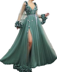 Green Floral Embellished Party Gown, Green Floral Party Gown, Green Tulle Dress For Gala, Long Sleeve Gown For Garden Party, Long Sleeve Tulle Gala Dress, Long Sleeve Tulle Dress For Gala, Green Long Sleeve Prom Gown, Elegant Green Dress With Floral Applique, Spring Garden Party Gown With Long Sleeves