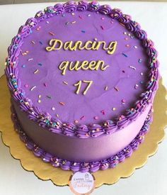 a cake with purple frosting and sprinkles that says dancing queen 17