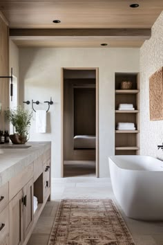 a bathroom with a bathtub, sink and towel rack on the wall next to it