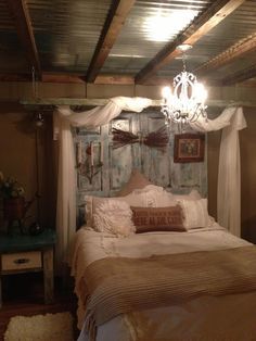 a bed sitting in a bedroom under a chandelier