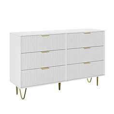 a white dresser with gold handles and drawers