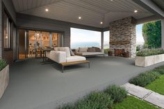 an outdoor living area with couches and tables