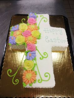 a cake decorated with flowers and the letter t on it is ready to be eaten